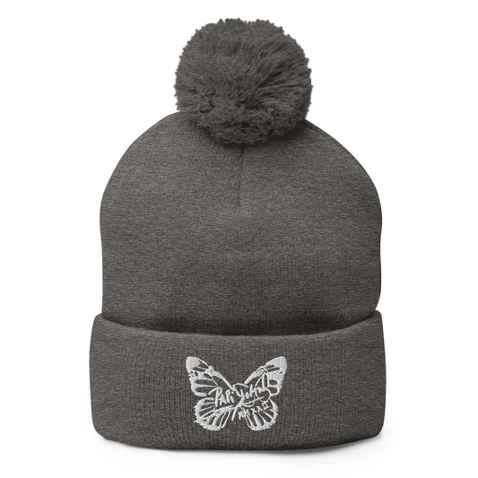 PapiJohn® The White Butterfly Pom-Pom Beanie in dark heather grey canvas front view tracking the beautiful definition of the central white butterfly thread design by $arah Free 💎 | High-End Subcultural Archive