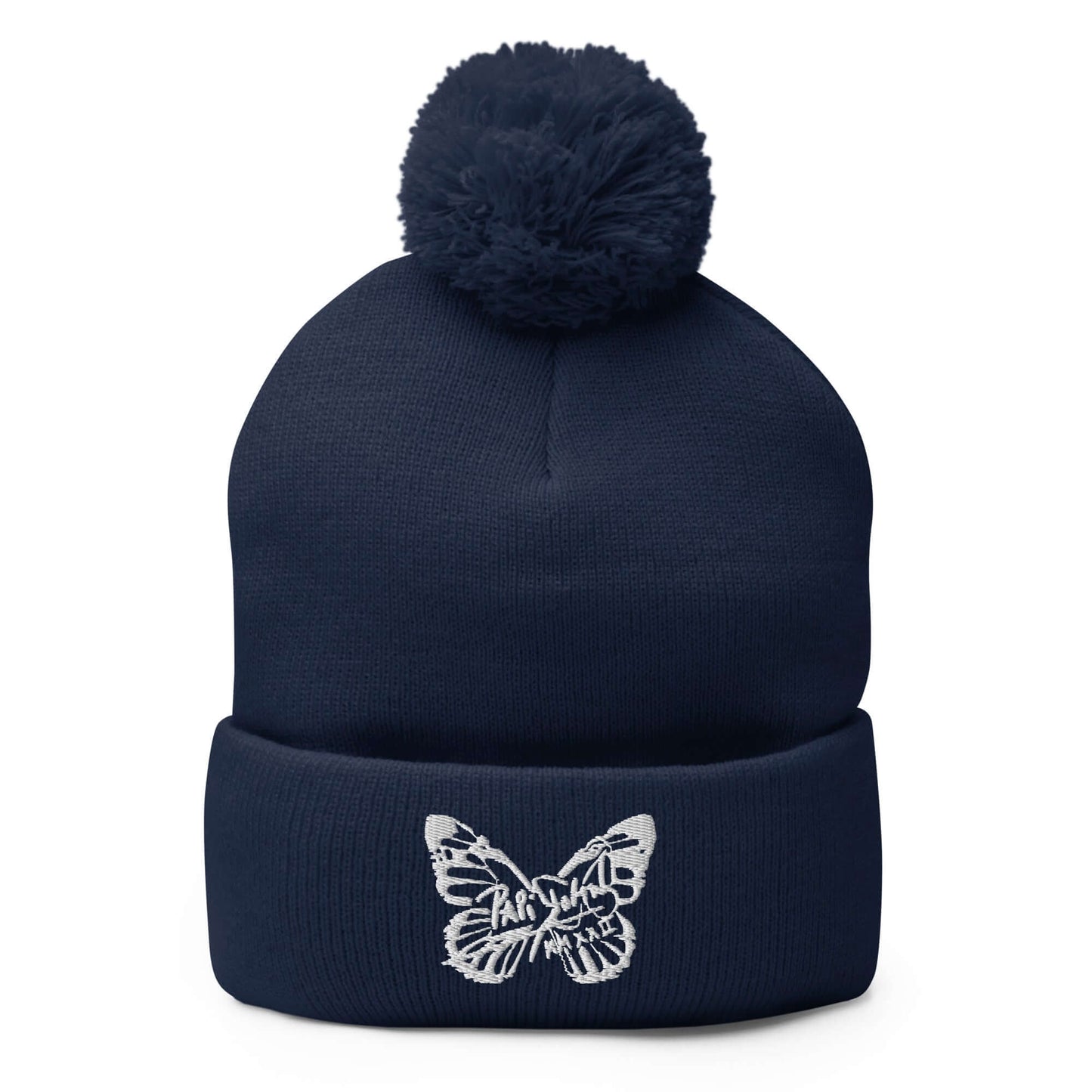 PapiJohn® The White Butterfly Pom-Pom Beanie in deep navy blue front view highlighting the crisp white embroidered butterfly icon contrast over the structured rib knit | Artist-Led Streetwear
