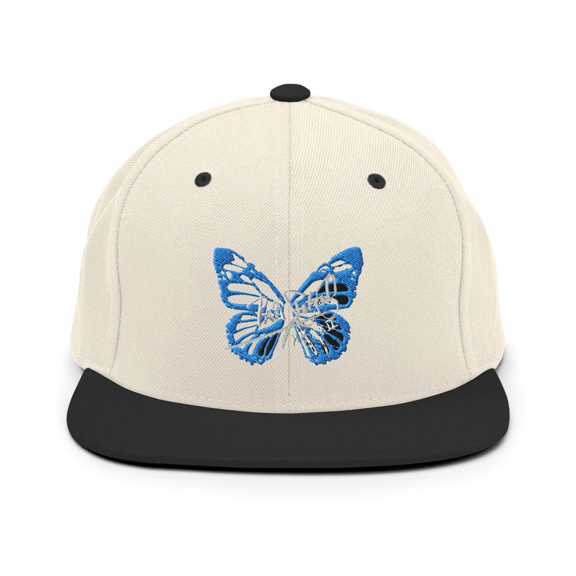 PapiJohn® The Blue Butterfly Snapback Archive in raw natural and black panels front view rendering the ultimate organic contrast for the blue butterfly thread | Sala 1 Wearable Art Fashion