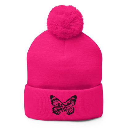 PapiJohn® The Butterfly Signature Pom-Pom Beanie in high-voltage neon pink front view highlighting the striking black embroidered butterfly icon by $arah Free 💎 | Wearable Art Fashion