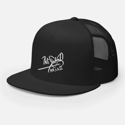 PapiJohn® The Flat Trucker Old School White Signature cap in solid black left half-profile three-quarter perspective highlighting the sharp contrast of the white calligraphic thread over the rigid front wall and dark mesh architecture | Artist-Led Streetwear