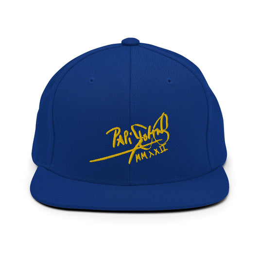 PapiJohn® The Gold Signature Classic Snapback in electric royal blue front layout tracking the intense reflection of the gold tridimensional script embroidery | Sala 1 Wearable Art Fashion