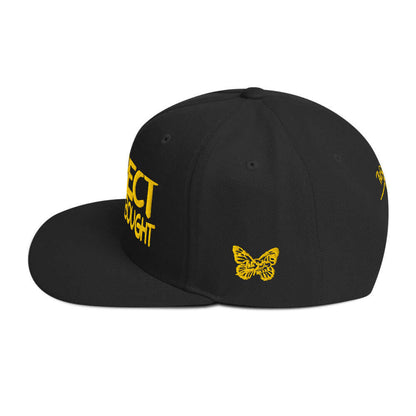 Left side view of the SALA 1 | The "Respect" Archive Gold Edition snapback cap by PapiJohn®. Detailed embroidered butterfly signature icon on the left panel. High-end streetwear and luxury streetwear de autor ideado en Cadifornia by $arah Free 💎.PapiJohn® The Respect Archive Gold Edition Snapback in solid black left side layout rendering the rigid crown elevation lines and flawless flat visor edge line by $arah Free 💎 | High-Tier Archive In Memory