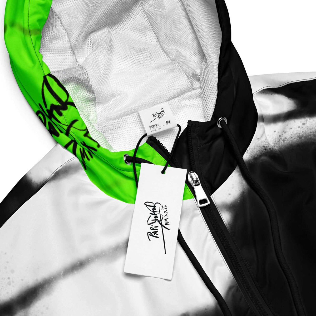 Close-up detail view highlighting the custom PapiJohn® brand tag, fluor neon green wing texture, and weather-resistant technical fabric on the SALA 3 | Crop Attitude Neon Monarca Windbreaker by $arah Free 💎. Honest luxury studio gear curated in Cadifornia.