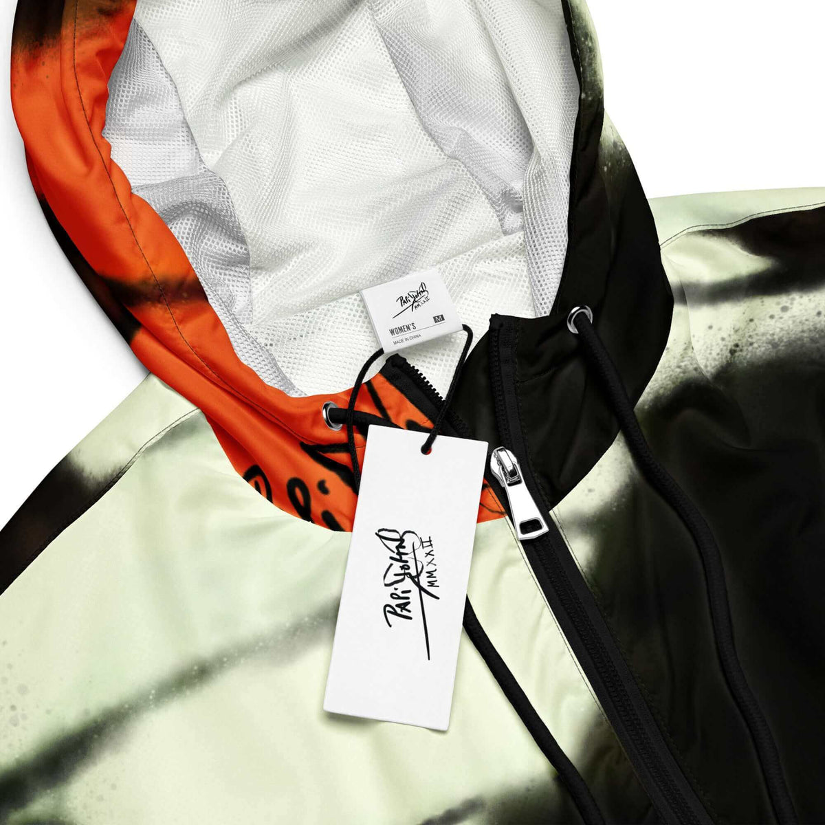 Close-up detail view highlighting the iconic heritage orange monarch butterfly print texture, weather-resistant technical fabric, and custom brand hardware on the SALA 3 | Artist Choice | Crop Monarca Origin Windbreaker by $arah Free 💎. Honest luxury studio gear curated in Cadifornia.