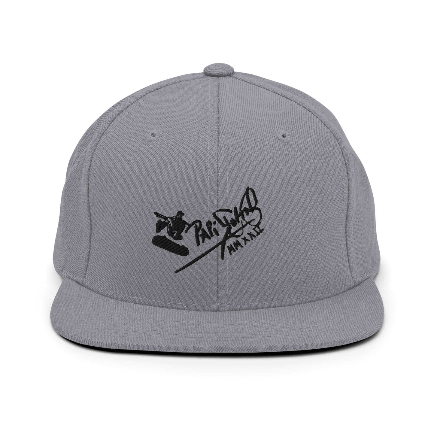 PapiJohn® The Skate Archive Signature Snapback in metallic silver canvas front view focusing on the clean definitions of the volumetric black embroidered text | Sala 1 Wearable Art Fashion
