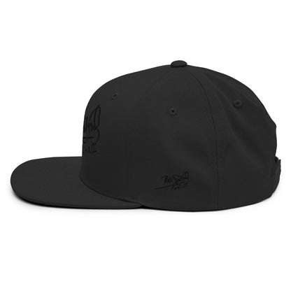 PapiJohn® The Black Signature Classic Snapback premium headwear macro left lateral view focusing on the deep black thread texture contrast of the original script embroidery and premium fabric weave by $arah Free 💎 | Artist-Driven Streetwear