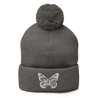 PapiJohn® The White Butterfly Pom-Pom Beanie in dark heather grey canvas front view tracking the beautiful definition of the central white butterfly thread design by $arah Free 💎 | High-End Subcultural Archive